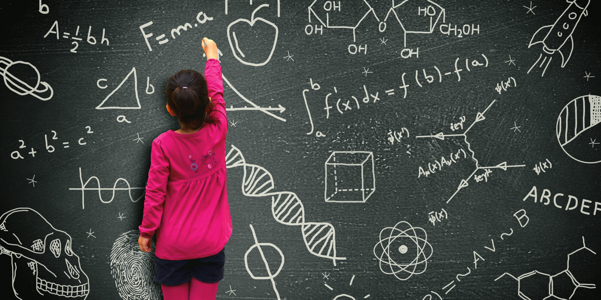 Little girl writing on blackboard - Learning and knowledge concept